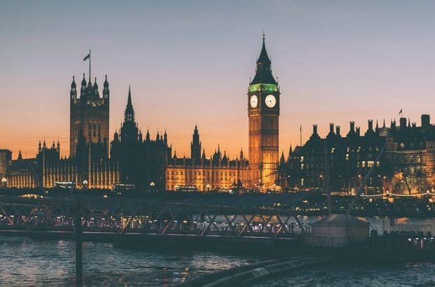 A photograph of the Houses of Parliament shortly after sunset.